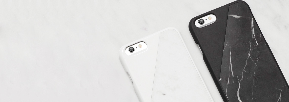 Two smartphones with white and black marble-patterned cases resting on a pale marble surface, calm monochrome mood